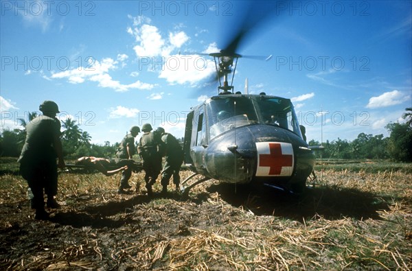 VIETNAM, Quang Nam-Danang, Hoi An, Area South of Danang.  Wounded soldier being put on a red cross helicopter during the main dust off.