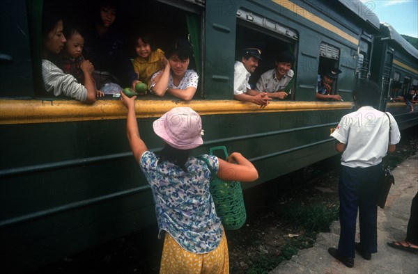 VIETNAM, Lang Co, Selling fruit to train passengers.