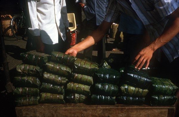 VIETNAM, Ho Chi Minh City, Tet delicacy of rice wrapped in banana leaves and steamed.