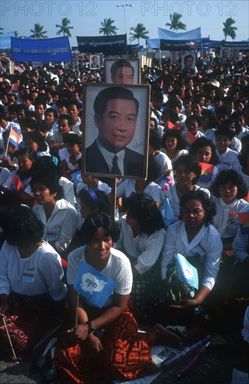 CAMBODIA, Phnom Pehn, "Crowds awaiting the arrival of Sihanouk outside the Royal Palace, many holding flags and posters."