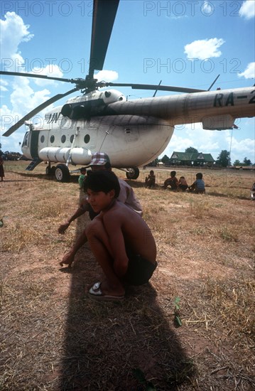 CAMBODIA, Genera, Politics, Young boys crouching in the shade cast by the blades of a UN helicopter.