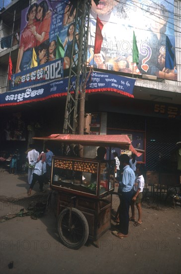 CAMBODIA, Phnom Pehn, Street vendor with a covered stall set on a handcart.