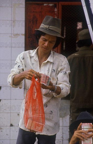 CAMBODIA, Neak Long, Money changer at the Neak Long ferry.