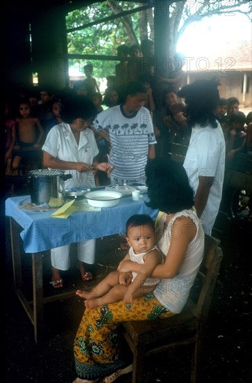 CAMBODIA, Tanko, Woman holding a child waiting to receive ICRC innoculation.