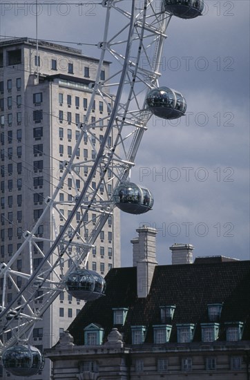 ENGLAND, London, Part view of the British Airways London Eye and buildings behind.