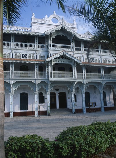 TANZANIA, Zanzibar Island, Zanzibar, "Stone Town. The Old Dispensary, four storey building with decorative balconies, built in the 1890s.  Exterior view with palms in the foreground. "