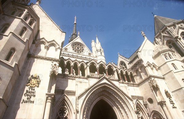 ENGLAND, London, "The Royal Courts of Justice, built in 1882.  Detail of exterior facade with name sign and coat of arms, seen from below. "
