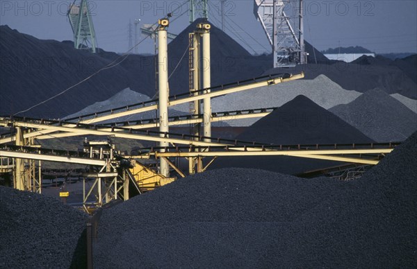 BELGIUM, Antwerpen, Antwerp, Coal stacked high on the docks