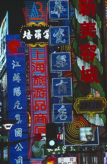 CHINA, Shanghai, Neon signs illuminated at night.