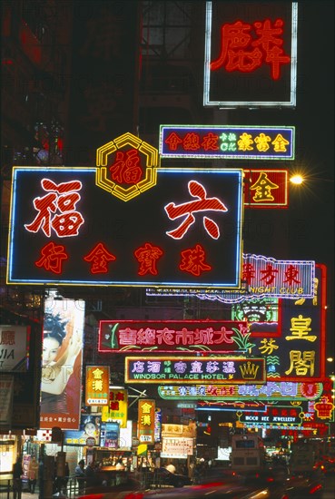 HONG KONG, Markets, Streets, Busy street with neon signs and advertising illuminated at night and traffic with streaked light trails.