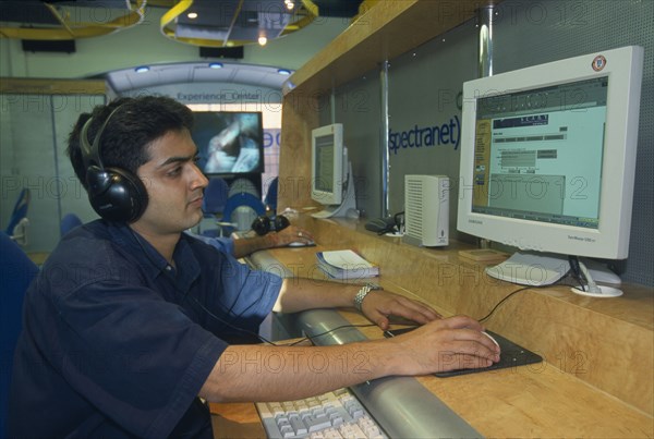 INDIA, Uttar Pradesh , New Dehli, Young man using the internet.