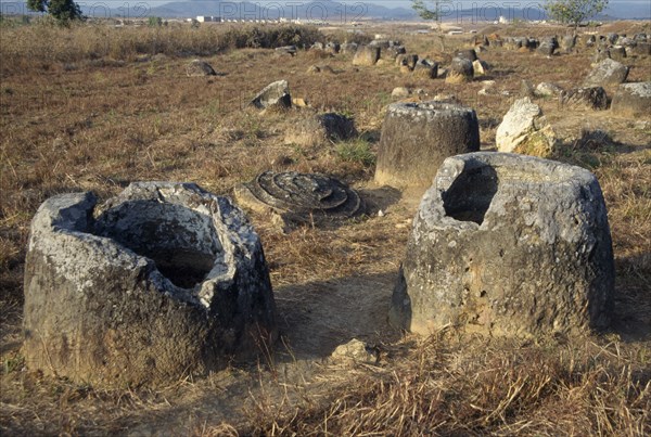 LAOS, Near Phonsavan, Plain Of Jars, Stone jars of unknown origin in the ground with lids fallen beside them