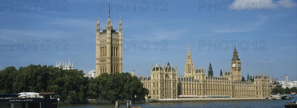 ENGLAND, London, Westminster, The Houses of Parliament and Big Ben with the River Thames in the foreground.