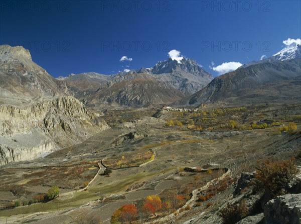 NEPAL, Annapurna Region, Jharkot, View over Jhong Khola Valley and the Thorung La pass to distant fortress town and Yakawa Kang mountain.