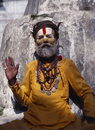 NEPAL, Kathmandu, "Hindu sadhu, follower of Shiva wearing saffron coloured  clothing and with painted face."