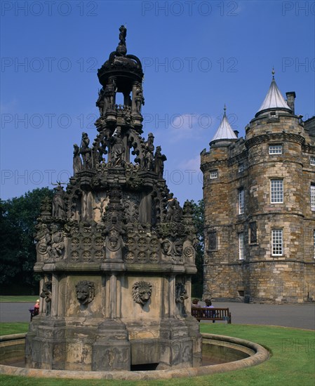 SCOTLAND, Lothian, Edinburgh, "Holyrood Palace, part view of western exterior with ornate carved, stone fountain in the foreground."