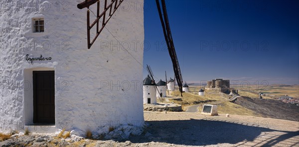 SPAIN, Castilla La Mancha, Line of white painted windmills.