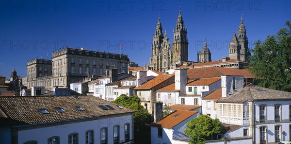 SPAIN, Galicia, Santiago de Compostela, "Cathedral, exterior and spires partly seen above rooftops of town."