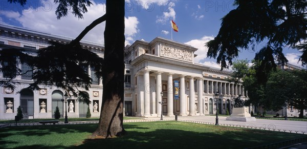SPAIN, Madrid State, Madrid, "Museo del Prado.  Neo-classical building designed by Juan de Villanueva in 1785, entrance and facade seen between trees in the foreground. "