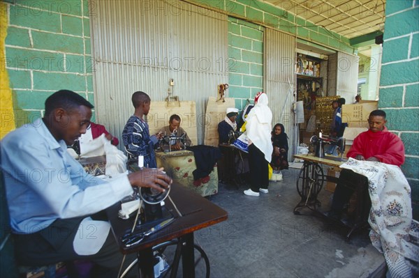 ETHIOPIA, Addis Ababa, "The Mercato, Africas largest market.  Group of men using hand powered sewing machines."