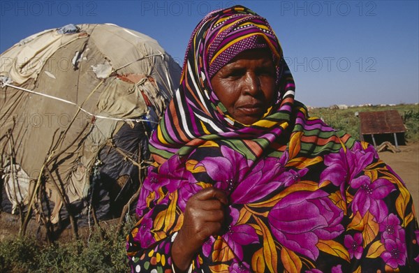 ETHIOPIA, Harerge Province, People, Somali woman refugee in a camp near the Somalia border.  Head and shoulders shot with shelter behind.