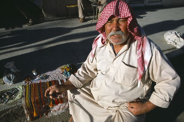 SYRIA, Central, Dayr-az-Zawr, Prayer bead vendor on roadside.