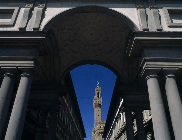 ITALY, Tuscany, Florence, Palazzo Vecchio.  View through colonnaded archway towards the Campanile.