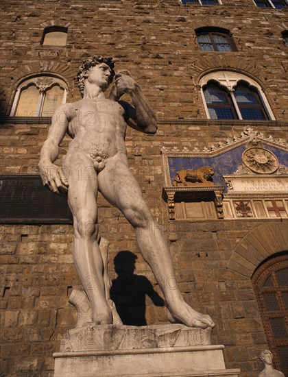 ITALY, Tuscany, Florence, Piazza della Signoria.  Copy of Michelangelos statue of David outside Palazzo entrance in evening light.