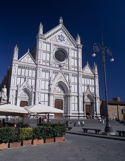 ITALY, Tuscany, Florence, Santa Croce Church  Neo-Gothic facade by Niccolò Matas added in 1863 with people on steps to entrance and in cafe in the piazza partly seen in the foreground.