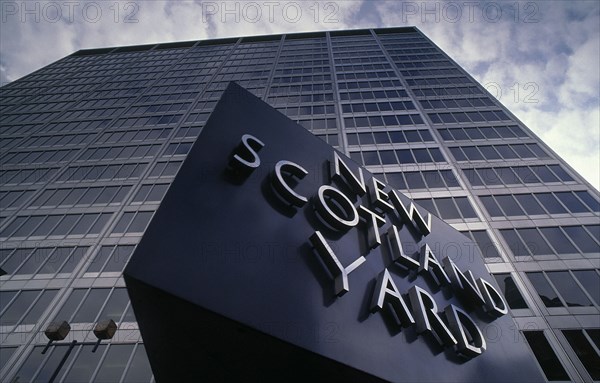 SOCIETY, Law and Order, Police, New Scotland Yard rotating sign with the London Metropolitan Police headquarters behind
