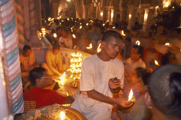 INDIA, Utter Pradesh, Vrindaven, "Dirwali festival, crowds of worshippers holding lighted candles inside temple. "