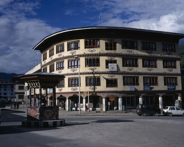 BHUTAN, Thimphu, High street shops with traffic policeman in kiosk in the foreground.