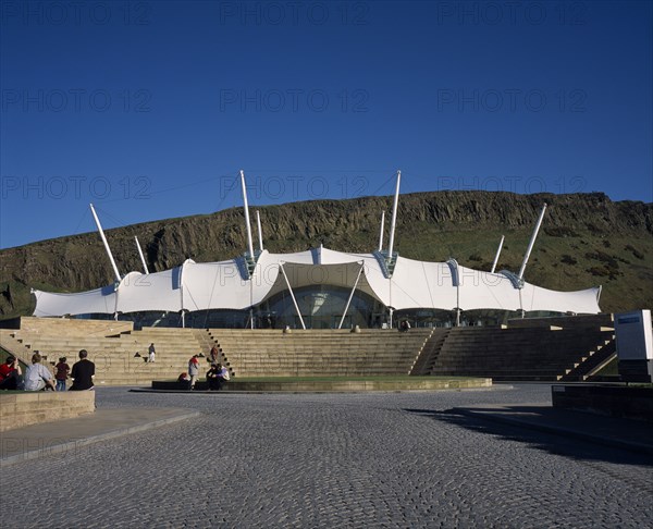 SCOTLAND, Lothian, Edinburgh, Holyrood Road.  Our Dynamic Earth Exhibition building exterior with Salisbury Craggs in the background.