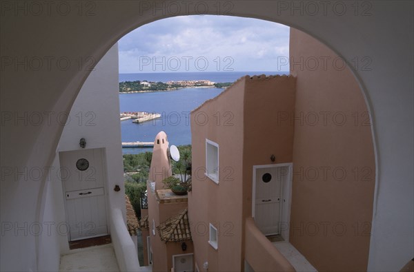 ITALY, Sardinia, Costa Smeralda, "Porto Cervo brightly painted apartment alley way, looking out over the harbour. "