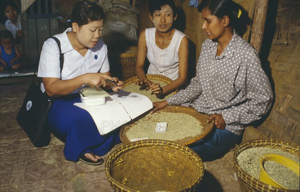 MYANMAR, Mandalay, Sexual health worker discussing the use of condoms with local women in rural area.
