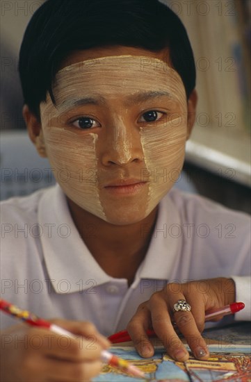 MYANMAR, Children, Single Girls, Young girl wearing thanaka paste on her face in traditional Burmese style.