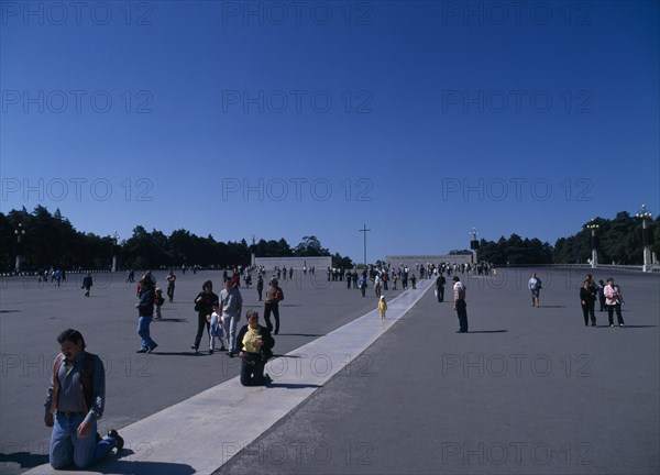 PORTUGAL, Biera Litoral, Fatima, Pilgrims on knees making thier way toward the church & shrine