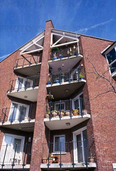 ARCHITECTURE, Housing, Flats, Balconies of newly built apartments erected on brown field site of former engineering works next to River Lagan