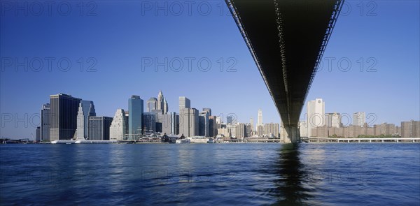 USA, New York State, New York, Lower Manhattan.  Post September 11 skyline from Brooklyn with underside of bridge in the foreground.