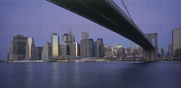 USA, New York State, New York, Lower Manhattan.  Post September 11 skyline from Brooklyn at dusk with Brooklyn Bridge in the foreground.