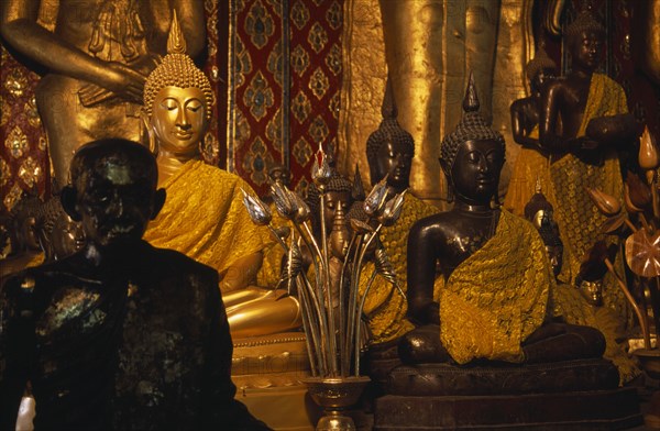 THAILAND, North, Chiang Mai, Wat Chedi Luang. Group of various Buddha statues in the main temple hall