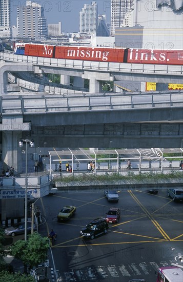 THAILAND, Bangkok, Sky Train above pedestrian walkways and road traffic at the junction of Rama 1 and Phaya Thai Road