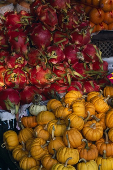 THAILAND, North, Chiang Mai, Wholesale Food Market.  Squash and Dragon fruit displayed on market stall.