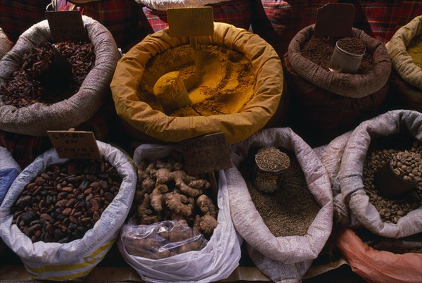 WEST INDIES, Guadeloupe, Grande-Terre, Pointe-à-Pitre.  Sacks of spices displayed on maket stall.