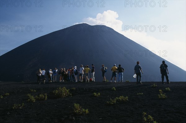GUATEMALA, Pacaya Volcano, Crater view of the volcano with a line of people looking toward the summit.