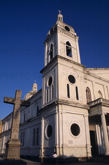 NICARAGUA, Granada, "Iglesia de La Merced, dating from 1781. External view of the bell tower with the dome in the background and stone cross in front."