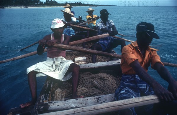 SRI LANKA, Industry, Fishing, Local fishermen laying drag nets from small rowing boat