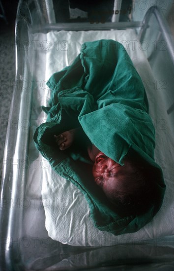 CUBA, Havana, Newborn baby wrapped in green towel in maternity hospital