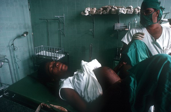 CUBA, Havana, Maternity hospital nurse with mother giving birth