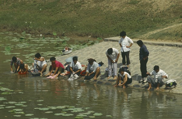 CHINA, People , Washing, Near the China plain. People washing their clothes in the river.